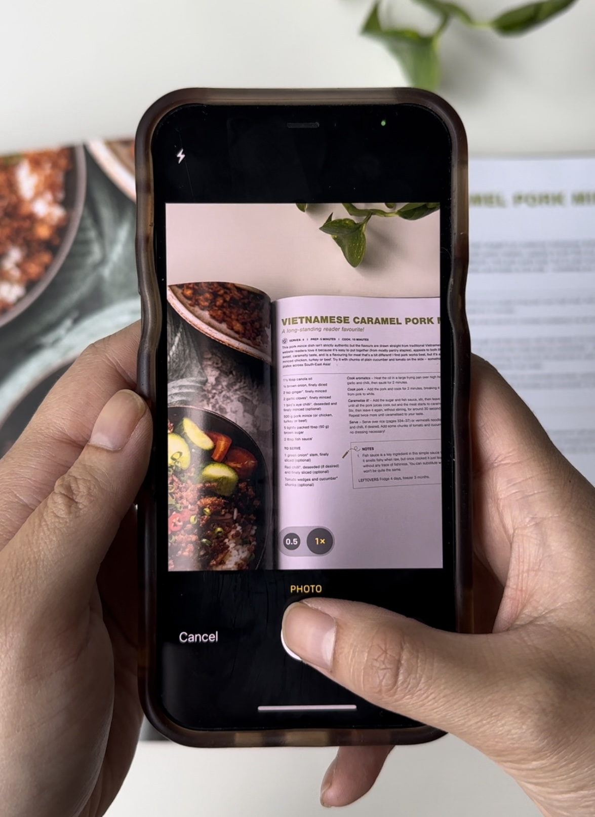 A phone taking a photo of a cookbook